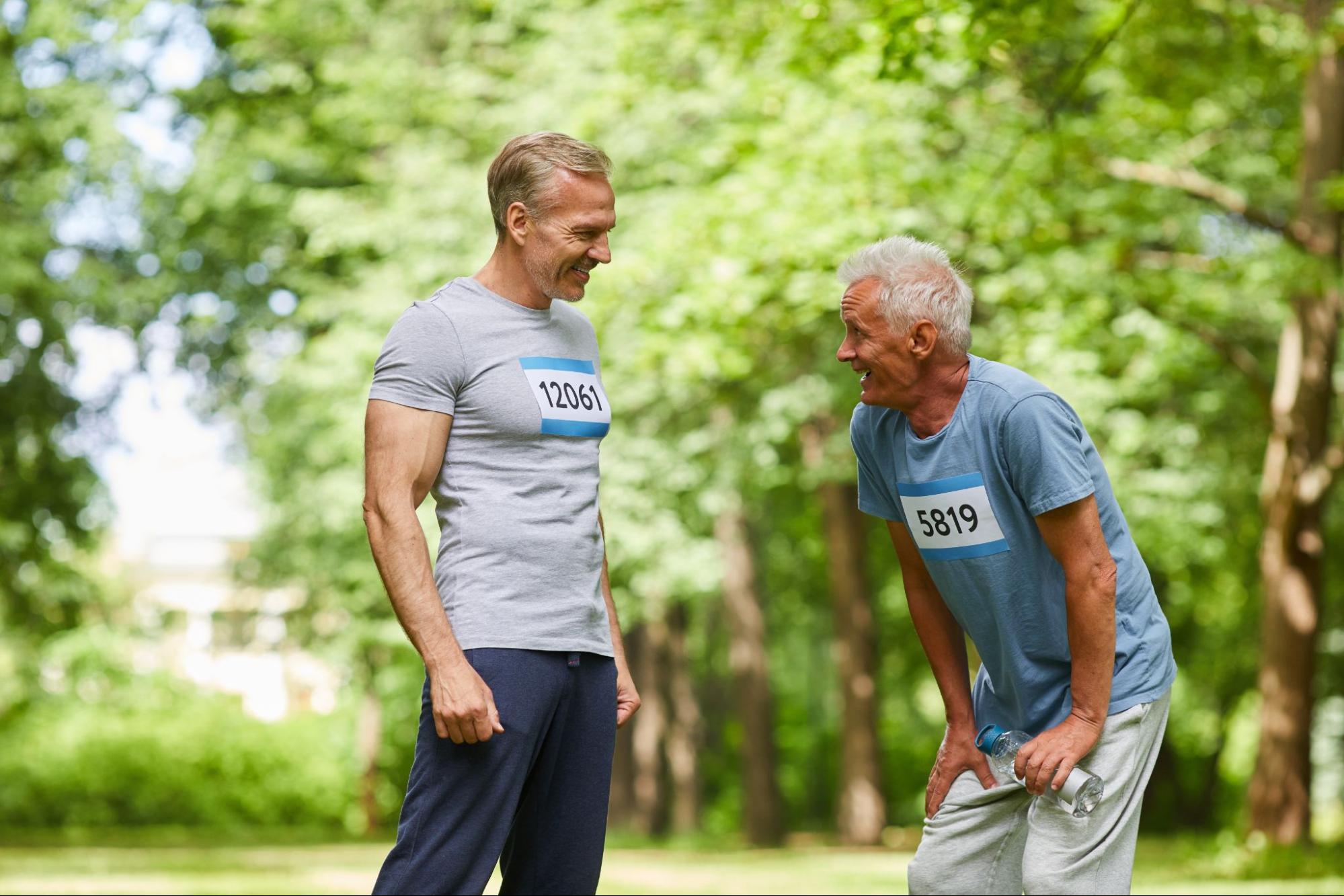 Middle-aged male marathon runners talking and bonding after training.