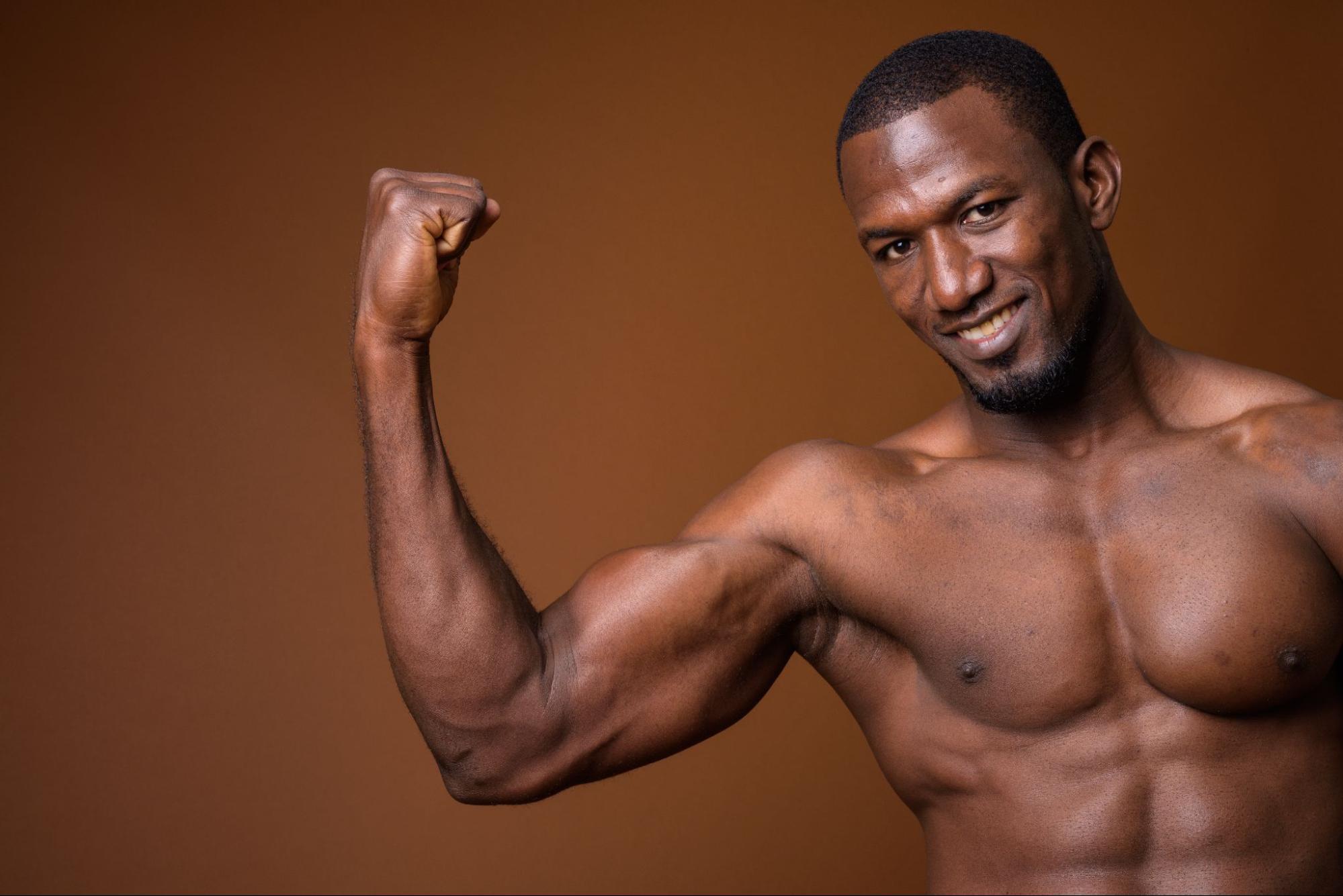 A muscular man flexes his strong bicep.