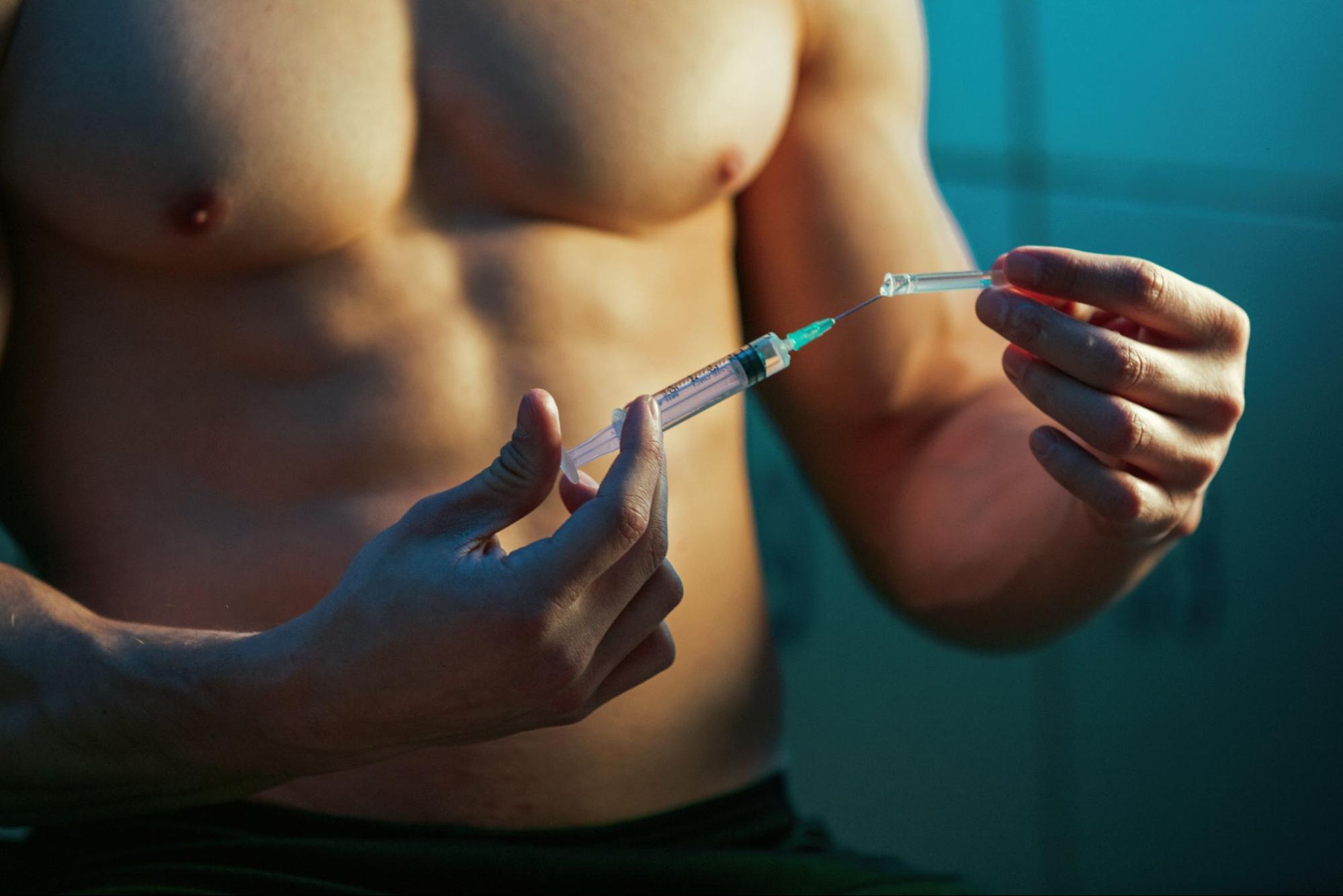 Cropped shot of a fit man preparing a testosterone injection syringe under medical guidance