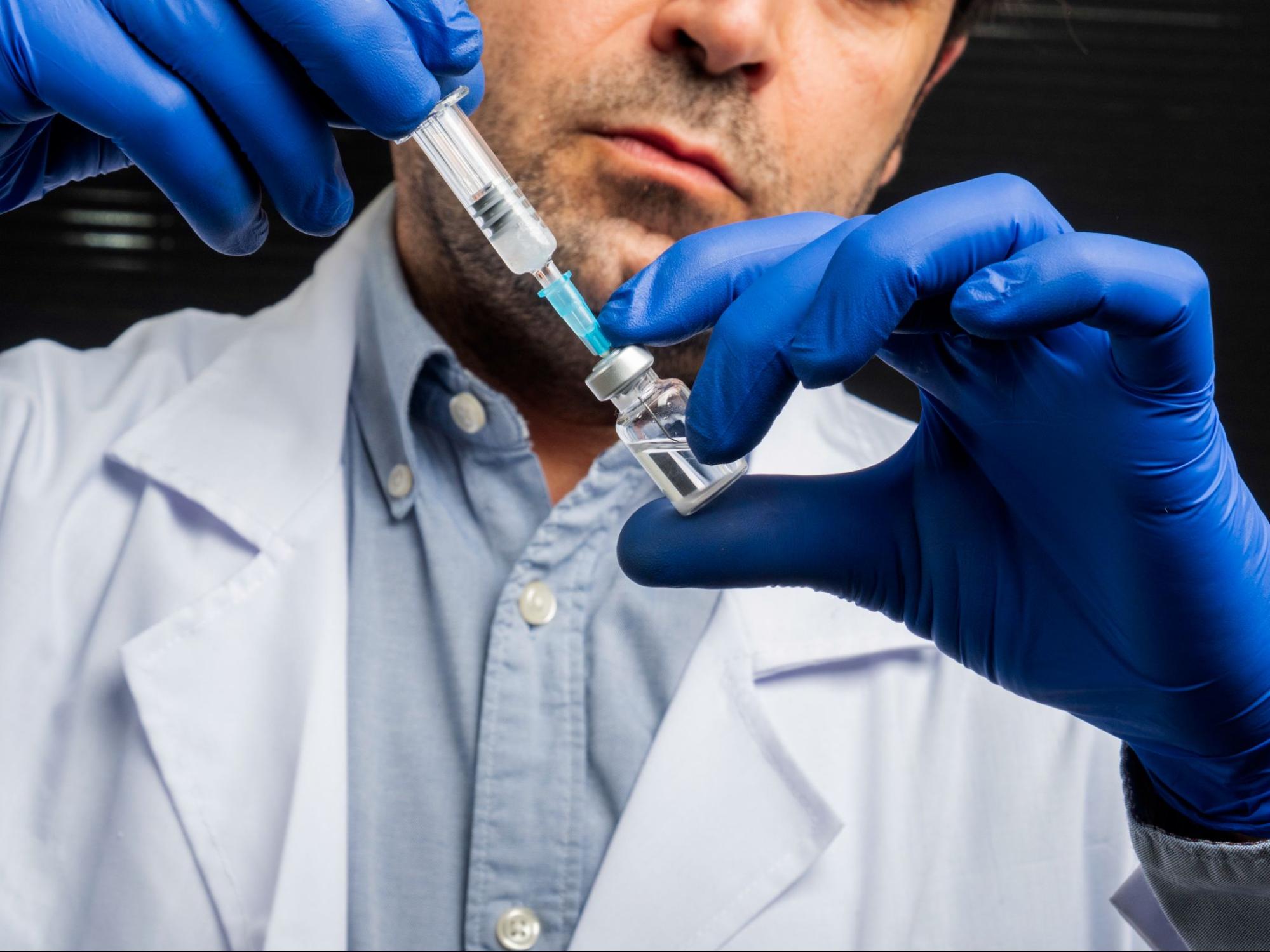 Close-up of a medical professional drawing injectable testosterone from a sterile vial